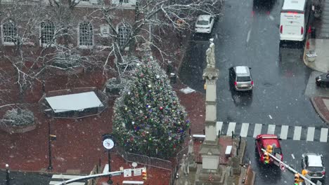 Snow-globe-flurries-over-American-town-square-with-Christmas-tree