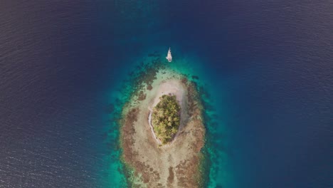Drone-clip-in-San-Blas-Islands-with-a-sailboat-anchored-in-a-remote-Island