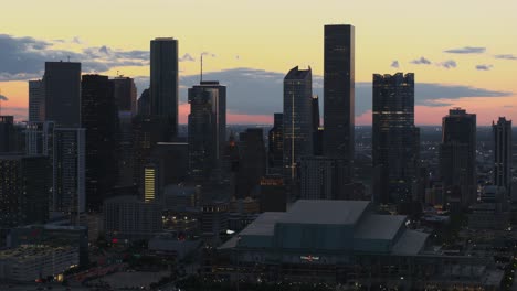 Drone-view-of-downtown-Houston,-Texas-at-night