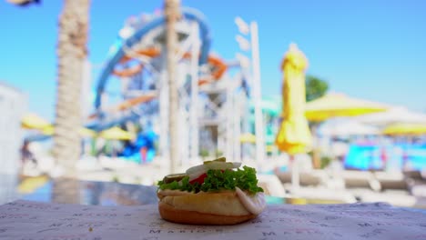 A-chief-making-a-delicious-sandwich-in-an-outdoor-amusement-park,-insert-shot,-close-up-shot,-push-in-shot