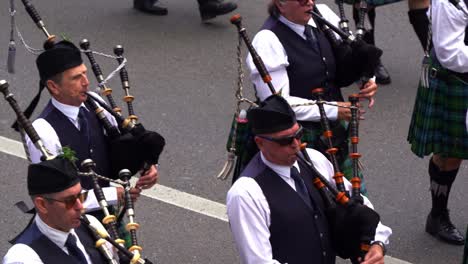 Close-up-shot-of-Brisbane-Pipe-Band,-pipers-and-drummers-in-traditional-attire,-playing-bagpipes-and-drums-for-Brisbane-City-during-the-annual-tradition-of-Anzac-Day-parade