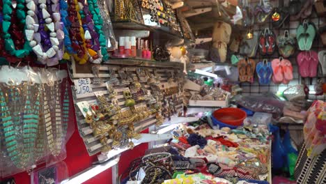 Woman-curiously-explores-items-available-for-sale-in-a-flea-market-shop