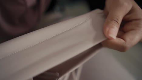 Closeup-shot-of-woman-checks-the-quality-of-the-goods-in-the-store