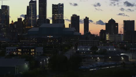 Ascending-drone-drone-from-trees-that-reveal-downtown-Houston-at-night