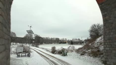 Drone-flight-under-the-historic-railway-viaduct-in-a-winter-setting