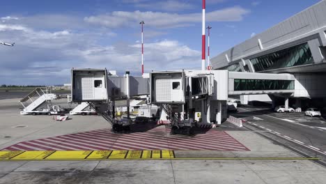 Exterior-view-of-inoperative-passenger-boarding-bridge-or-jetway-or-aerobridge-at-airport-terminal-of-Rome-in-Italy