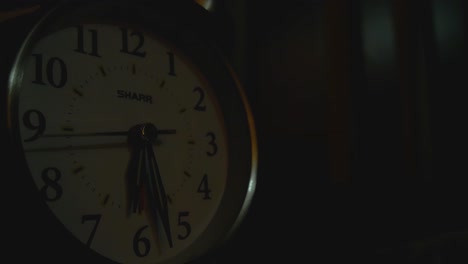Old-analog-alarm-clock-ticking-in-bedroom-long-shot-for-timelapse