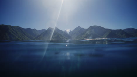 Glistening-view-of-Tahitian-mountain-valleys-on-sunny-day-from-Teahupoo-surf-break