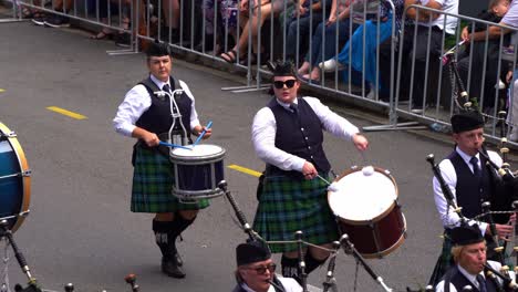 Brisbane-Pipe-Band,-pipers-and-drummers-in-traditional-attire,-playing-bagpipes-and-drums-for-Brisbane-City-during-the-annual-tradition-of-Anzac-Day-parade,-close-up-shot