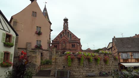 Eguisheim's-Saint-Léon-square-is-dominated-by-the-castle-and-in-the-middle-stands-a-fountain-with-a-statue-of-St