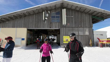 Skiers-get-off-the-chair-lift-and-leave-the-terminal-building-at-Nassfeld,-Austria