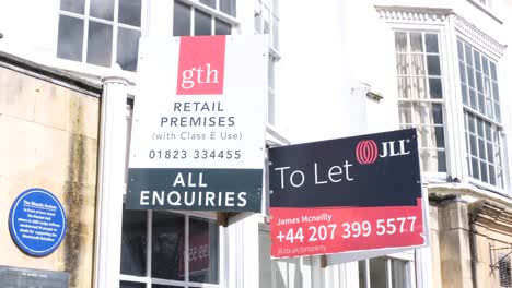 Close-up-of-property-estate-agency-signs-on-retail-business-property-for-sale-in-Southwest-of-England-UK