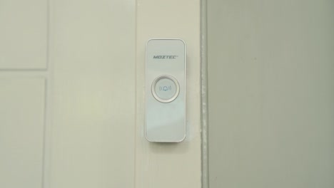 Ringing-Doorbell-with-Finger-at-Day-Close-Up,-side-view