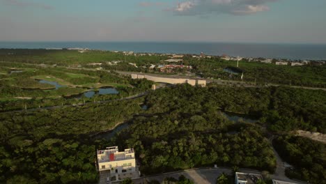 aerial-rising-over-rainforest,-in-front-the-sea-at-sunrise,-riviera-maya,-quintana-roo,-mexico