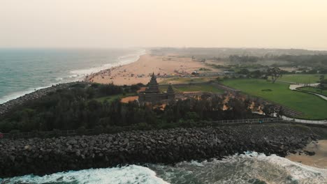 Aerial-Dolly-Back-VIew-Of-Shore-Temple-With-Beach-Coastline-Background