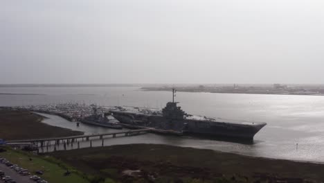 Aerial-close-up-panning-shot-of-the-historic-USS-Yorktown-CV-10-aircraft-carrier-at-Patriot's-Point-in-Mount-Pleasant,-South-Carolina