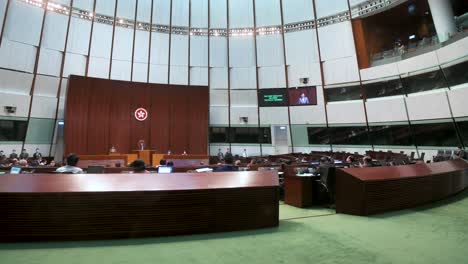 A-wide-view-of-Carrie-Lam,-former-Hong-Kong's-chief-executive,-is-seen-on-the-main-chamber's-screen-as-she-delivers-the-annual-policy-address-at-the-Legislative-Council-building