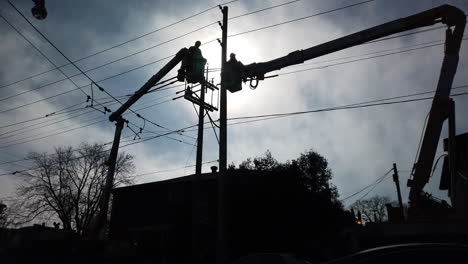 Low-angle-wide-shot-of-Toronto-Hydro-workers-working-high-up-on-a-crane