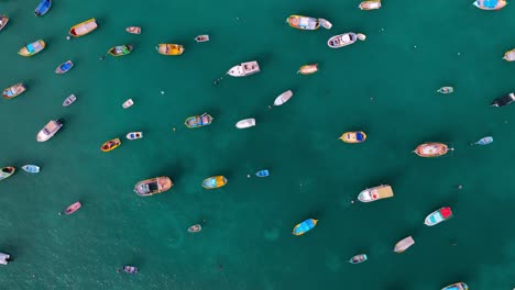 Aerial-top-down-shot-of-fishing-boat-anchored-in-the-bay