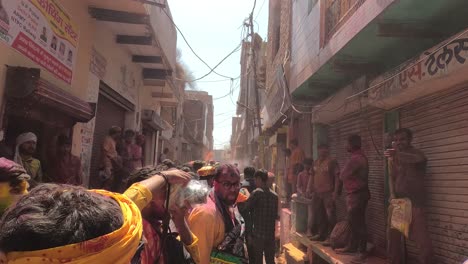 pov-shot-Many-people-are-making-their-way-to-the-temple-where-they-are-enjoying-the-color-flying-and-dusting