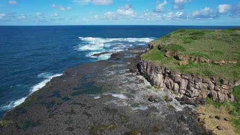 Rocky-Cliff-Of-Cook-Island-In-Australia-At-Daytime---Aerial-Pullback