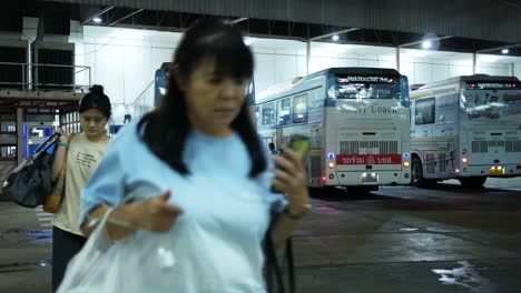 Passengers-coming-from-the-other-side,-going-to-their-designated-platform-at-a-bus-terminal-in-Bangkok,-Thailand