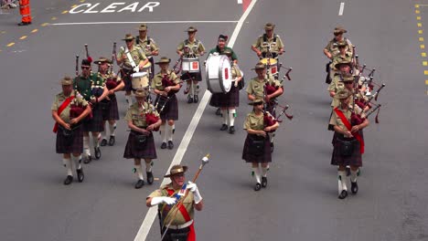 National-Servicemen's-Band,-pipers-and-drummers-in-traditional-attire,-playing-bagpipes-and-drums-for-Brisbane-City-during-the-annual-tradition-of-Anzac-Day-parade,-close-up-shot