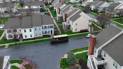 Driver-and-delivery-truck-of-UPS-leaving-american-residential-area