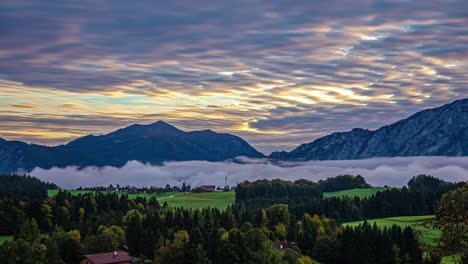 Mist-and-moody-clouds-move-over-Alps-in-Austria-during-sunrise-timelapse