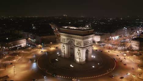 Triumphal-arch-at-night-and-Paris-cityscape,-France