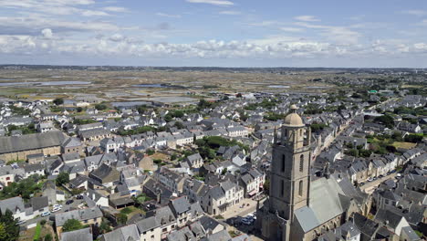 Circular-Tracking-Aerial-of-Small-Town-With-Church-Tower-and-Salt-Marshes