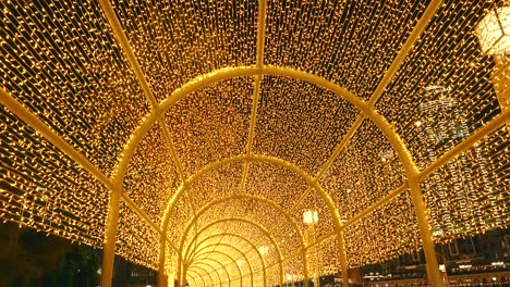 Crowd-of-tourists-walking-under-colorful-lights-in-Dubai-mall