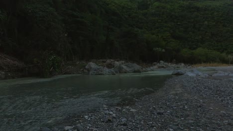 Flying-over-water-surface-of-Muchas-Aguas-river,-San-Cristobal-in-Dominican-Republic