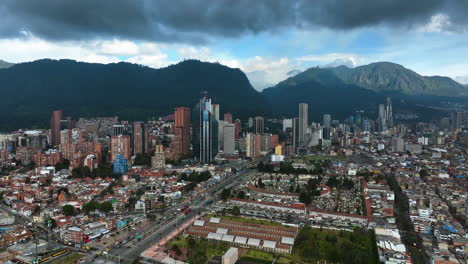 Establishing-drone-shot-orbiting-the-downtown-of-Bogota,-cloudy-day-in-Colombia