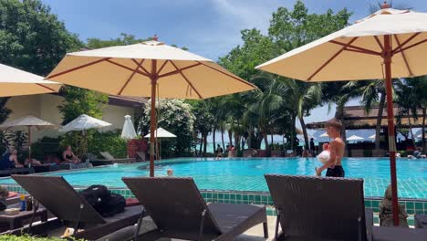 People-relaxing-at-a-tropical-resort-pool-overlooking-the-sea-in-Phi-Phi-islands