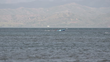 Static-shot-of-a-Panga-boat-travelling-past-Cebaco-Island-Veraguas