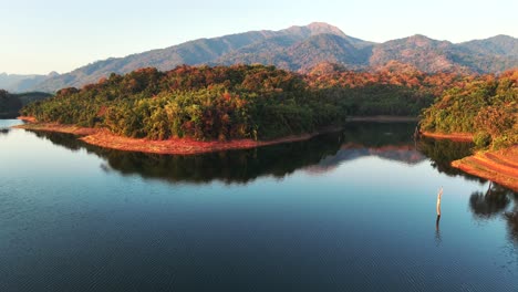 Bird's-eye-view-of-Khao-Laem-National-Park-in-Thailand-showcases-a-serene-lake-reflecting-lush-green-mountains