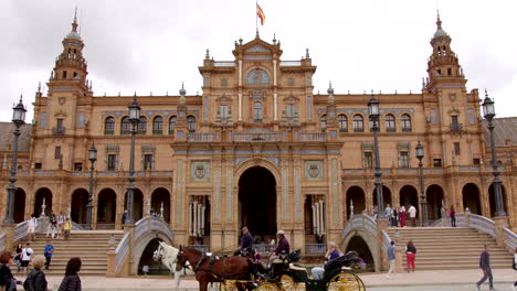 Horse-Carriage-Ride-At-Plaza-de-España-In-Front-Of-Pavilion-Buildings-In-Seville,-Spain