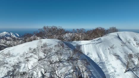 Luftaufnahme-über-Dem-Gipfel-Des-Myoko-Bergs,-An-Einem-Klaren-Wintertag-An-Der-Küste-Und-Mit-Dem-Meer-Im-Hintergrund