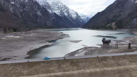 Car-riding-through-Alpine-Lake-Klöntalersee,-Switzerland