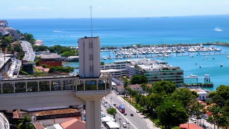 Aerial-view-of-Elevador-Lacerda,-the-city-around-and-the-sea-at-the-background,-Salvador,-Bahia,-Brazil