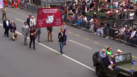 Representatives-from-the-Seventh-Battalion-Royal-Australian-Regiment-Association-Queensland-walking-down-the-street,-participating-in-annual-Anzac-Day-parade