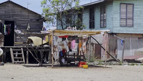 Man-sitting-in-a-poor-village-setting-in-Hanuabada-Village-in-a-makeshift-shelter