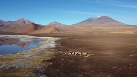 Aerial-rises-above-abandoned-old-building-foundation-ruin-in-Atacama