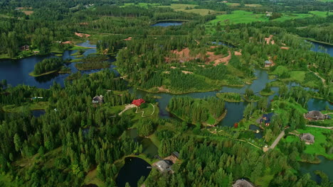 Drone-shot-of-houses-on-the-small-islands-in-the-kemeri-bog-near-Salas,-Latvia