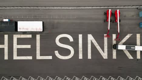 "helsinki"-lettering-in-the-city's-harbor-filmed-from-above,-helsinki,-finland,-europe,-drone