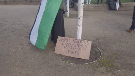 Close-up-of-a-homemade-sign-next-to-the-Palestine-flag