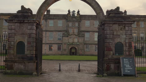 Profile-view-of-entrance-of-Lyme-house-under-cloudy-day-in-Greater-Manchester,-England