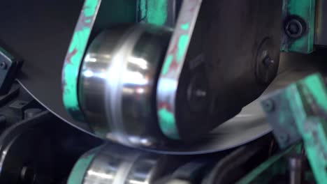 Close-shot-of-robotic-arm-precisely-welds-the-interior-seams-of-drum-cans