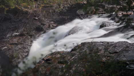 A-powerful-and-tumultuous-waterfall-cascades-in-the-rocky-riverbed-amidst-the-summer-forest